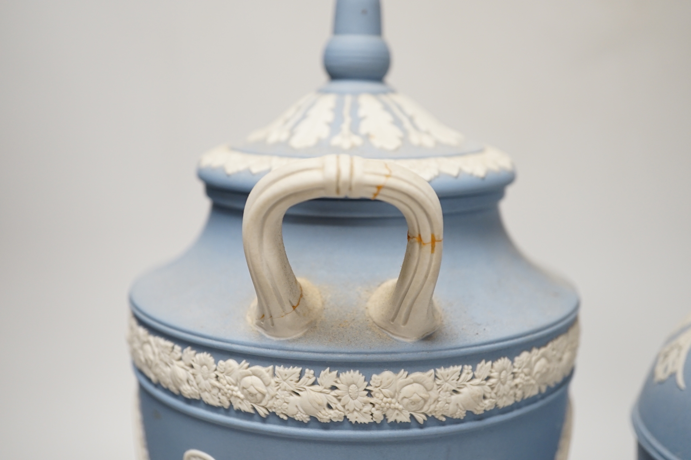 A Wedgwood blue jasper commemorative urn and cover and a similar smaller urn and cover, tallest 31cm